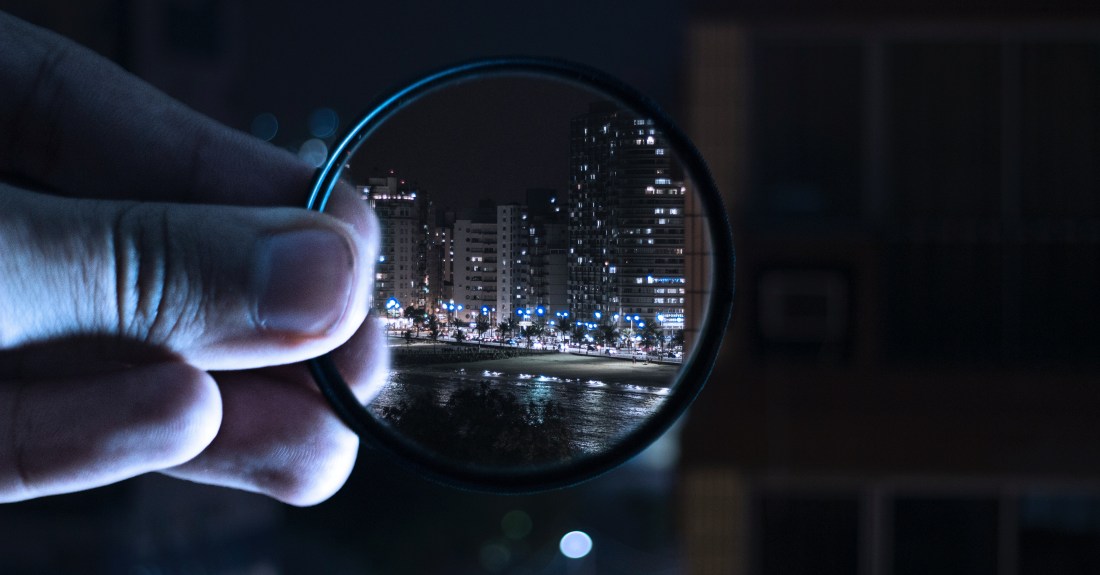 person-holding-magnifying-glass-712786